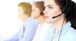 © rogerphoto - Call center operators at work. Focus at  business woman in headset