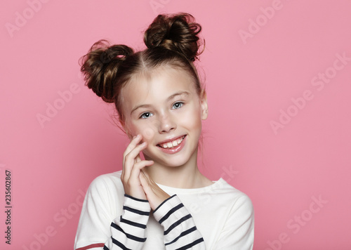 Cute girl 7-8 year old posing in studio over pink background – kaufen