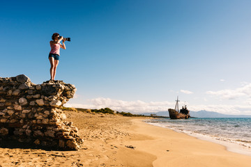 Wall Mural - Tourist take photo on beach sea shore