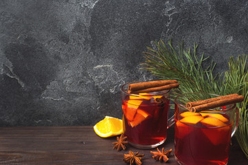 Wall Mural - Christmas mulled red wine with spices and fruits on a wooden rustic table. Traditional hot drink at Christmas time