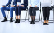© rogerphoto - Group of business people sitting in office and waiting for job interview while using gadgets, close-up. Conference or training concepts