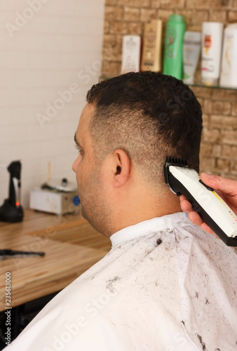 Back View Of Man Getting Short Hair Trimming At Barber Shop With