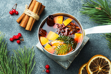 Wall Mural - Christmas mulled wine with spices and fruit on the table. New year concept