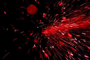 bright red sparks on black background