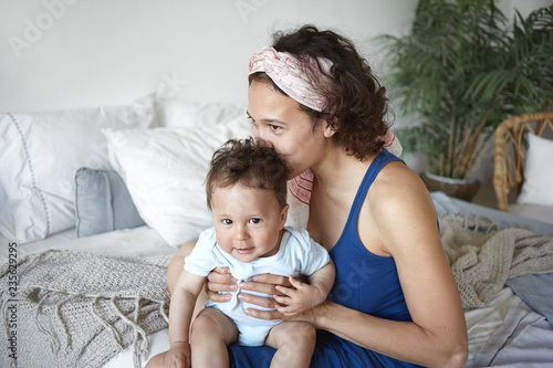 Indoor Shot Of Attractive Cheerful Young Mixed Race Female With
