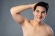 © Atstock Productions - Portrait of smiling shirtless young handsome Asian man with hand in hair
