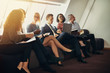 © Flamingo Images - Diverse group of businesspeople sitting on an office sofa