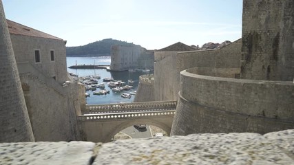 Wall Mural - Inner gate bridge connecting Fort Revelin to Ploce Gate, with the Old Harbour and the Adriatic Sea in the background, Dubrovnik.