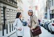 © Halfpoint - Man and woman business partners standing outdoors in city of Prague, talking.