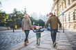 © Halfpoint - A rear view of small toddler boy with parents walking outdoors in city.