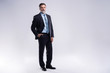 © opolja - Full length portrait of confident mature businessman in formals standing isolated over white background.