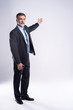 © opolja - Full length Portrait Of Happy Mature Businessman Presenting Isolated On White Background.