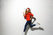 © Drobot Dean - Full length portrait of an excited girl wearing hoodie jumping