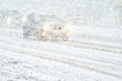Car rides through a snowstorm. Limited vision on the road. Blizzard - car traffic in bad weather conditions