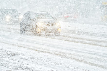 Car Rides Through A Snowstorm. Limited Vision On The Road. Blizzard - Car Traffic In Bad Weather Conditions