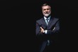 © opolja - Handsome mature business man isolated on black background