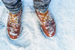 © v_sot - First person view of legs in brown boots in the snow. Snow on boots while walking in winter