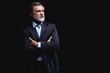 © opolja - Handsome mature business man isolated on black background