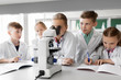 © Syda Productions - education, science and children concept - kids or students with microscope studying biology at school laboratory