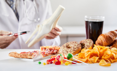 Doctor showing link between bad food and disease