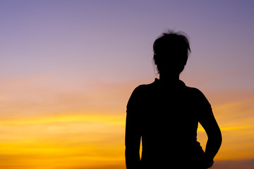 Wall Mural - Young woman relaxing with sunset