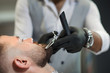 © serhiibobyk - Closeup of process of cutting beard of client in barber shop