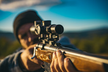 Close Up Snipers Carbine At The Outdoor Hunting. Hunter Aiming Rifle In Forest. Hunter With Shotgun Gun On Hunt. Hunter With Powerful Rifle With Scope Spotting Animals.