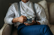 © LUMINA IMAGES - Unrecognisable elegant man holding a cup of coffee.