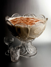 Close Up Of Butterscotch Scotch Eggnog Served In Glass Against Gray Background