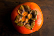 © Andrew Scrivani - Overhead view of persimmon fruit on wooden table
