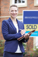 Wall Mural - Portrait Of Female Realtor Standing Outside Residential Property