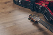 © Krisada - an acoustic guitar and leather guitar hard case with black sash on the wooden floor