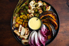 Overhead View Of Roasted Autumn Vegetables With Aioli Sauce