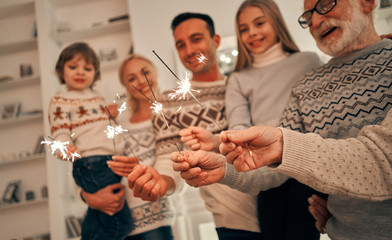 Wall Mural - The happy family with bright sparklers