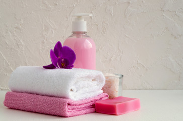 Liquid soap and two towels on a white background.