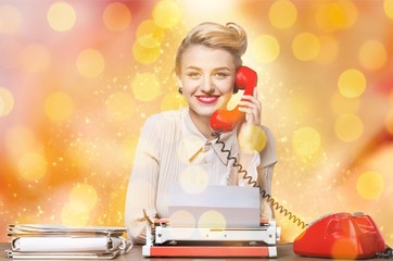 Attractive young woman working on vintage typewriter