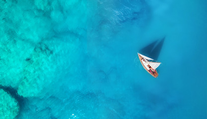 Wall Mural - yacht on the water surface from top view. turquoise water background from top view. summer seascape 