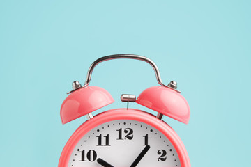 red alarm clock on blue background