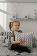 © combo1982 - Little beautiful girl with light pillows in a cozy room.