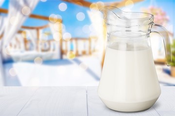 Poster - Glass jug of fresh milk isolated on white