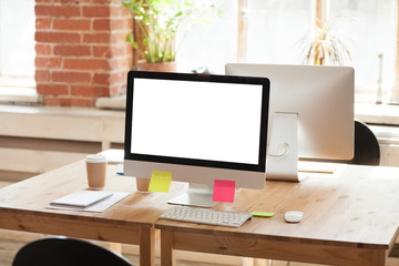 Office worker, manager, business person empty, without people workplace with computer with white mock up at screen, colorful stickers, joint workplace