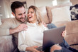 © ivanko80 - Happy couple using laptop at home
