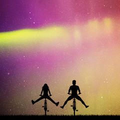 Sticker - couple on bikes in park at night. vector illustration with silhouettes of two cyclists with legs apa