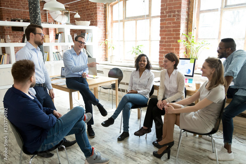 Fotografía Happy smiling coach, tutor, boss laughing at female employee joke at briefing, c