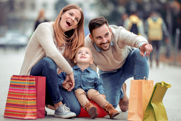 Wall Mural - Happy family in the city after shopping