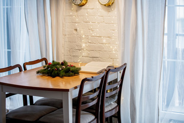 Wall Mural - open boook and Christmas decoration on a table in a kitchen.