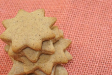 Star Shaped Spiced Christmas Cookies On Pink Jute Background