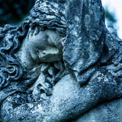 Statue of woman on tomb as a symbol of depression and sorrow