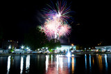 Fototapeta Tęcza - Fireworks at night on the water