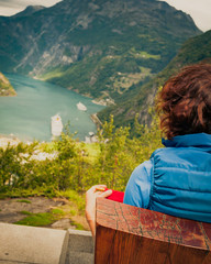 Canvas Print - Tourist enjoying Geirangerfjord from viewing point